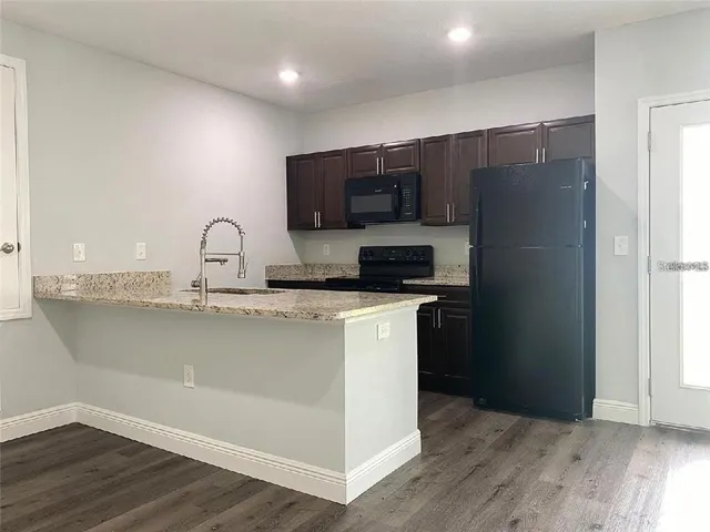 a kitchen with a refrigerator and a sink