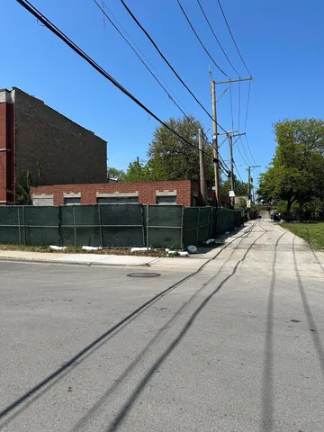 a view of a street with a car parked
