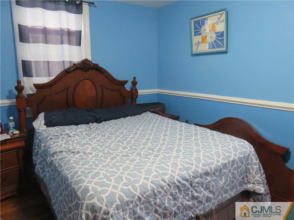 267 Rector Street Perth Amboy, NJ 08861 - Photo 15 of 17 a bedroom with a bed and painting on the wall