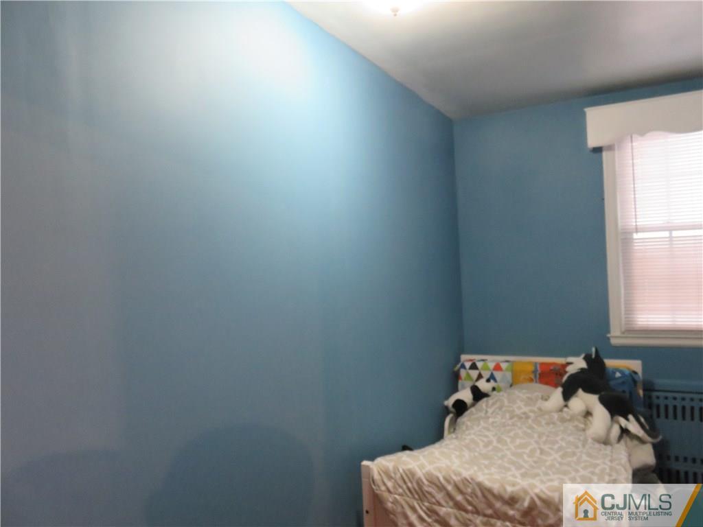267 Rector Street Perth Amboy, NJ 08861 - Photo 17 of 17 a bedroom with a bed and window