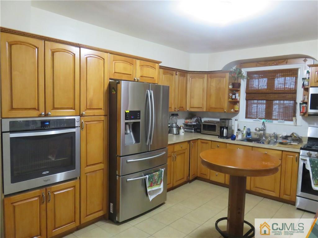 267 Rector Street Perth Amboy, NJ 08861 - Photo 6 of 17 a kitchen with granite countertop a refrigerator and furniture