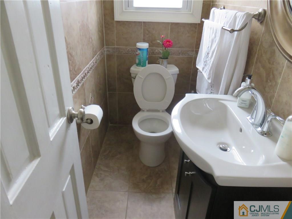 267 Rector Street Perth Amboy, NJ 08861 - Photo 7 of 17 a bathroom with a sink and a toilet