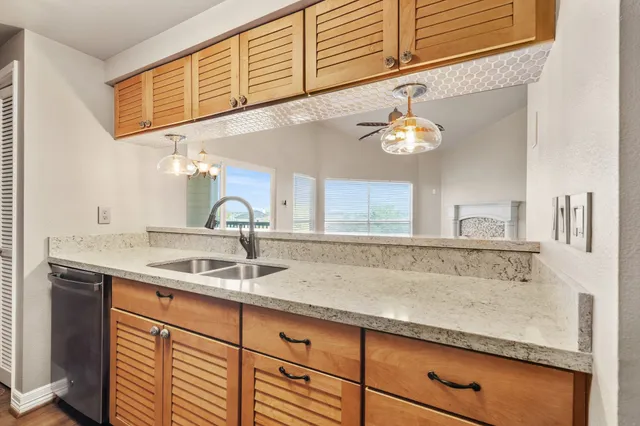 a sink with a granite countertop sink and a window