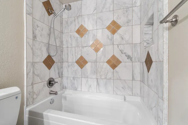 a bathroom with a bathtub and shower