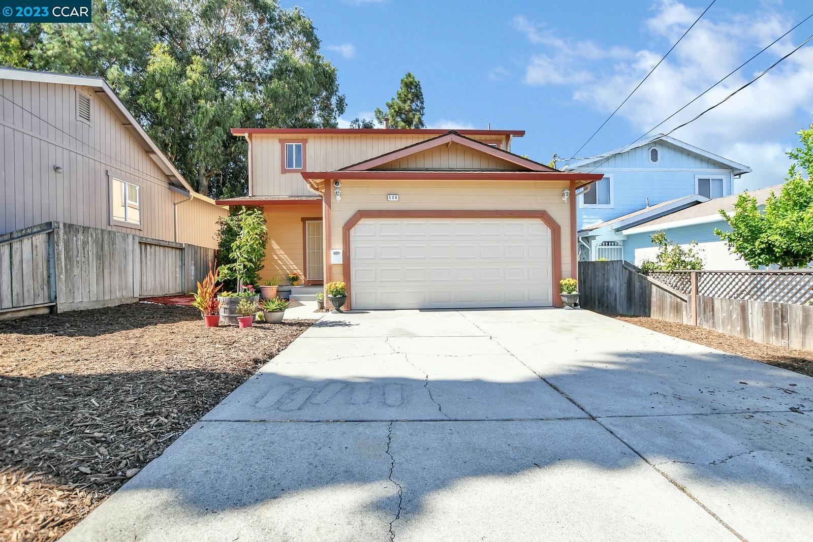 506 Garretson Avenue Rodeo, CA 94572 - Photo 1 of 1 a front view of a house with a yard and garage