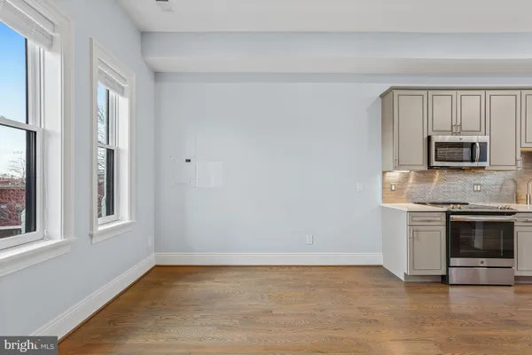 a kitchen with stainless steel appliances a sink a stove and microwave