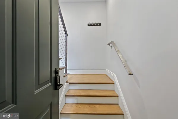 an empty room with wooden floor and cabinet