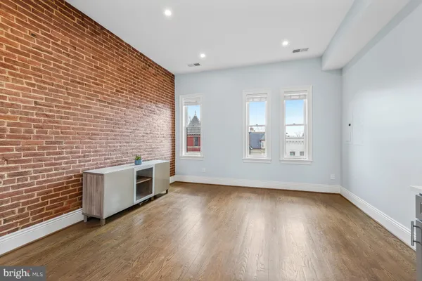a kitchen with stainless steel appliances a refrigerator and a stove top oven