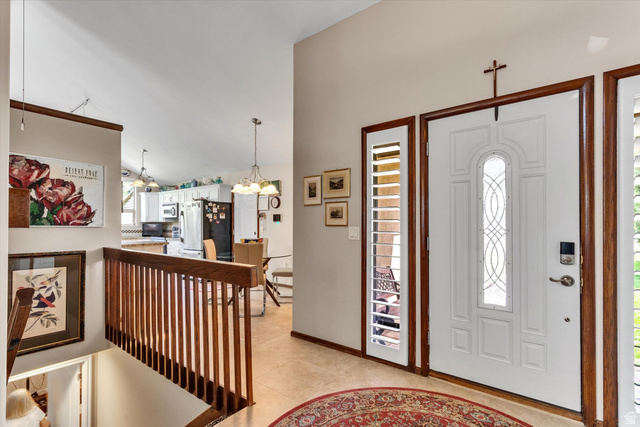 2863 Fallentine Road Sandy, UT 84093 - Photo 12 of 48 Entryway featuring a decorative white front door with leaded glass, framed by side panel windows with louvered shutters