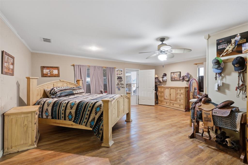 1644 County Road 195 Dublin, TX 76446 - Photo 12 of 34 a spacious bedroom with a bed a table and chair