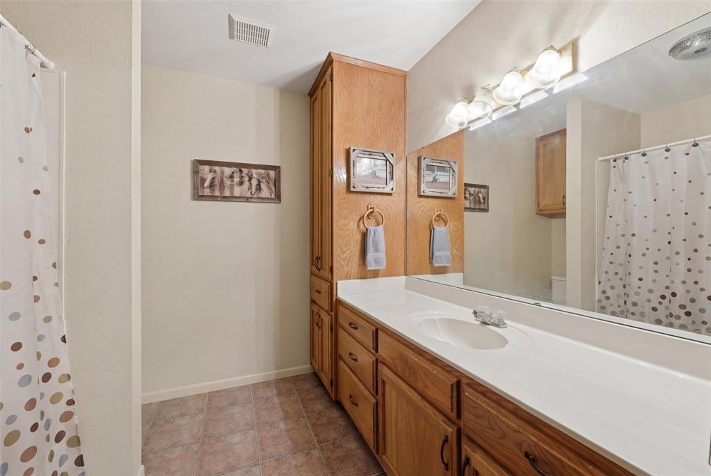 1644 County Road 195 Dublin, TX 76446 - Photo 15 of 34 a bathroom with a sink a vanity and a mirror