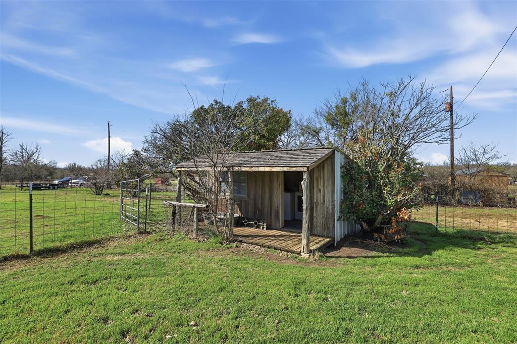 1644 County Road 195 Dublin, TX 76446 - Photo 21 of 34 a view of a house with backyard and a tree
