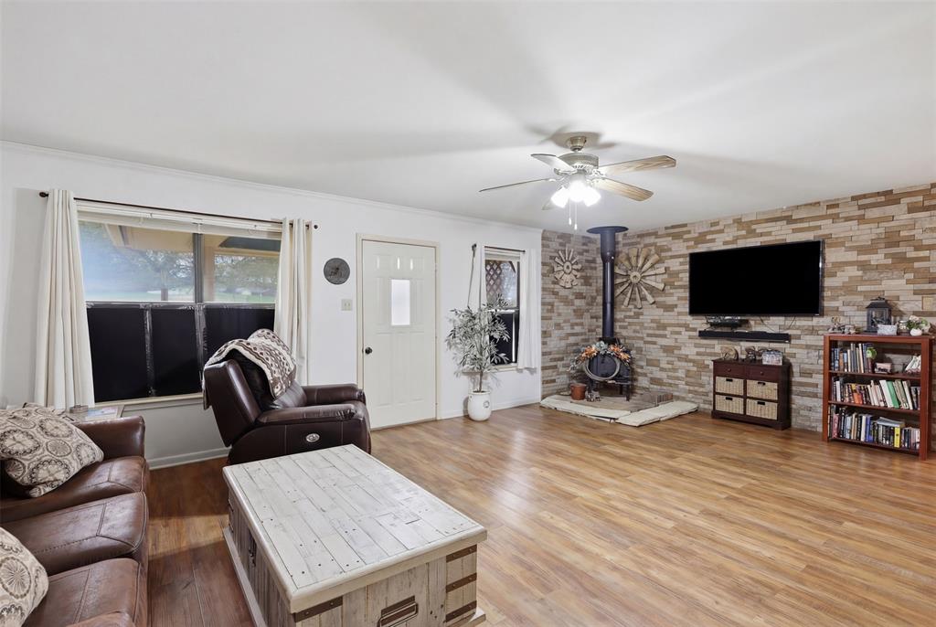 1644 County Road 195 Dublin, TX 76446 - Photo 7 of 34 a living room with furniture and a flat screen tv