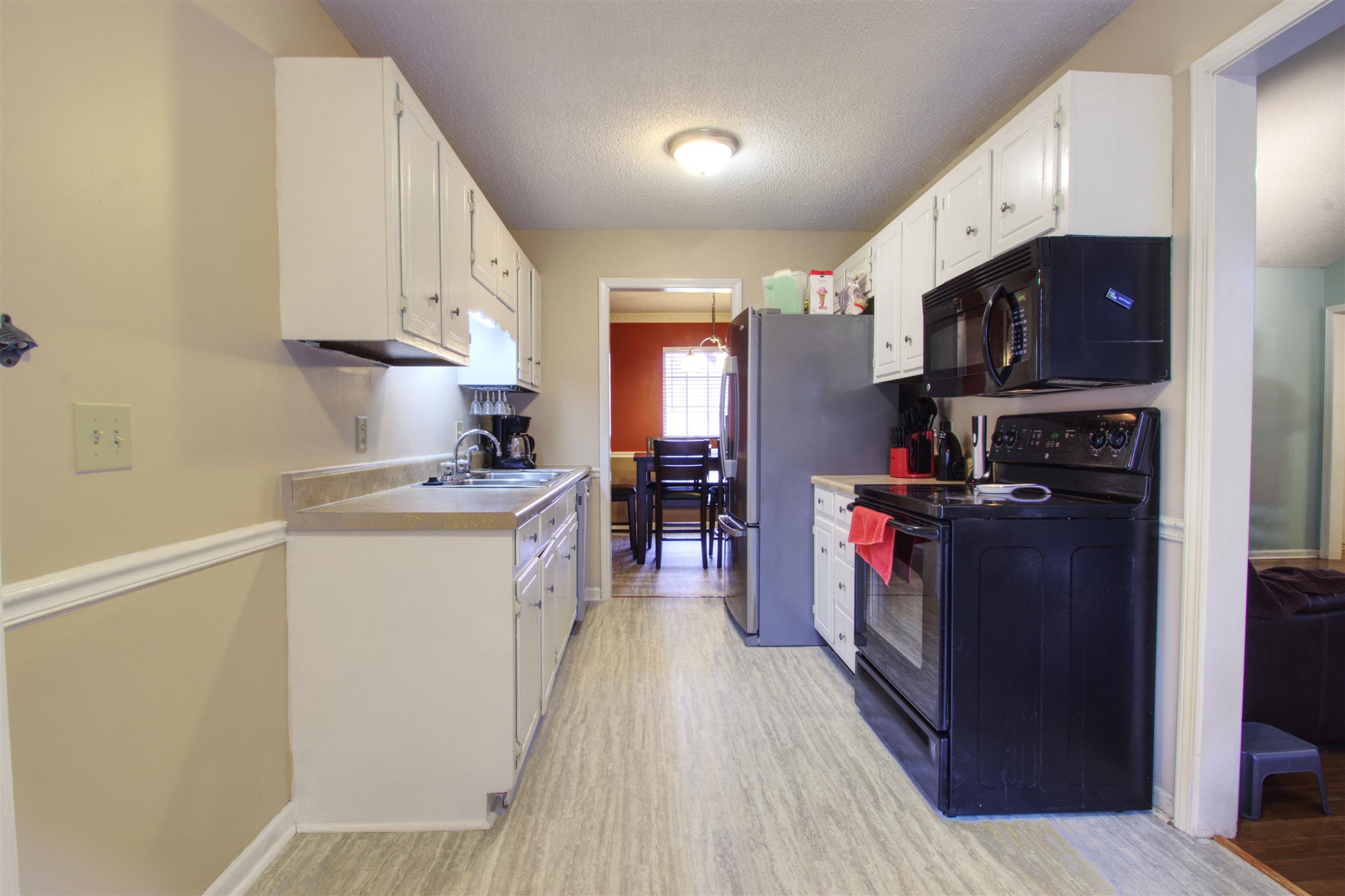 804 Fall Court Antioch, TN 37013 - Photo 6 of 14 a kitchen with a refrigerator and a stove top oven