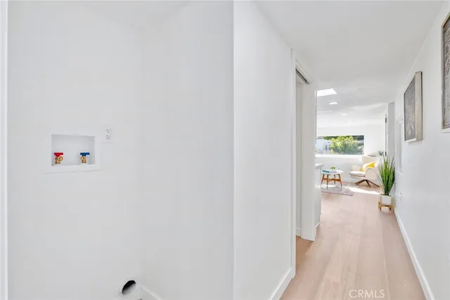 a living room with furniture and a painting on the wall