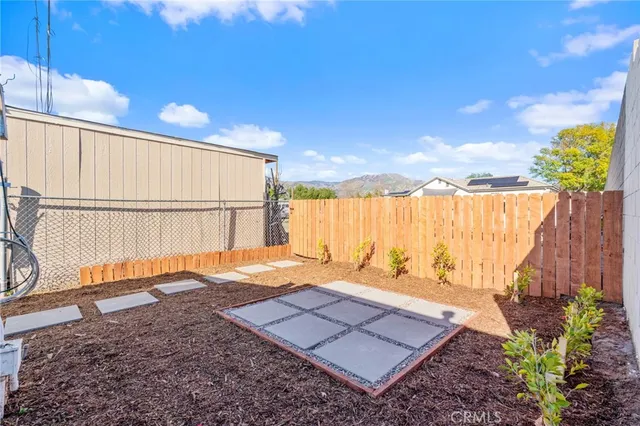 a view of a backyard with a wooden fence