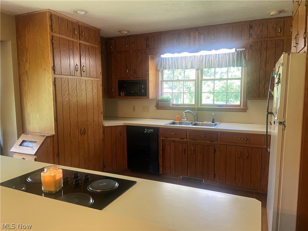 2445 South Elyria Road Wooster, OH 44691 - Photo 9 of 46 Kitchen featuring brown cabinetry, light countertops, and appliances