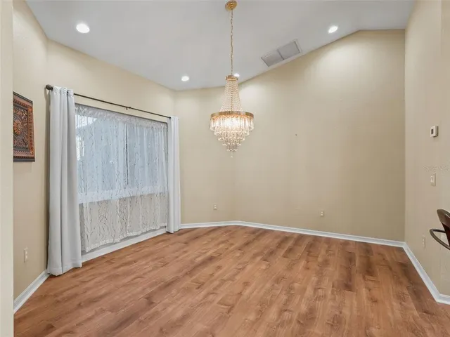 a kitchen with stainless steel appliances granite countertop a stove top oven a sink dishwasher and a microwave oven with large wooden cabinets