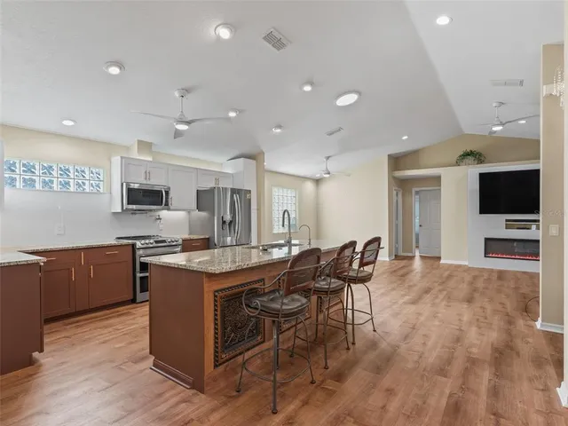 a large bathroom with a large counter top a sink and a mirror