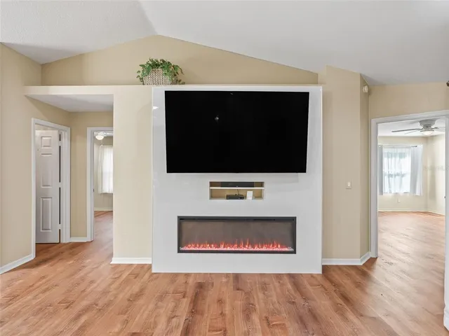 a bathroom with a granite countertop sink a mirror a vanity and a shower