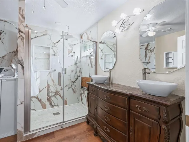 a bedroom with a large bed and a chandelier