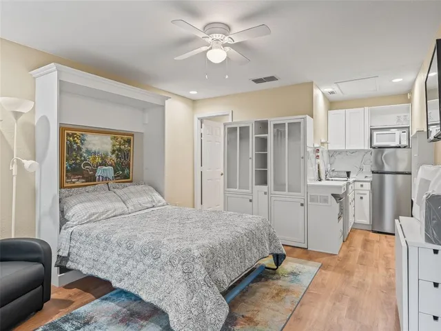 a view of a patio with table and chairs potted plants and wooden fence