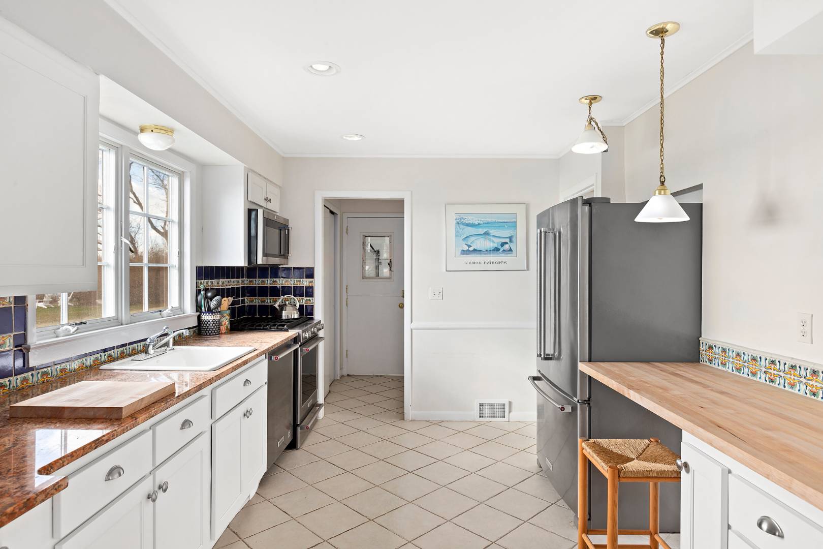 69 Ferry Road Sag Harbor, NY 11963 - Photo 10 of 17 a kitchen with a sink stove and refrigerator