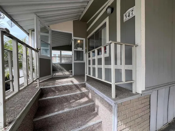 a view of staircase with white walls and windows