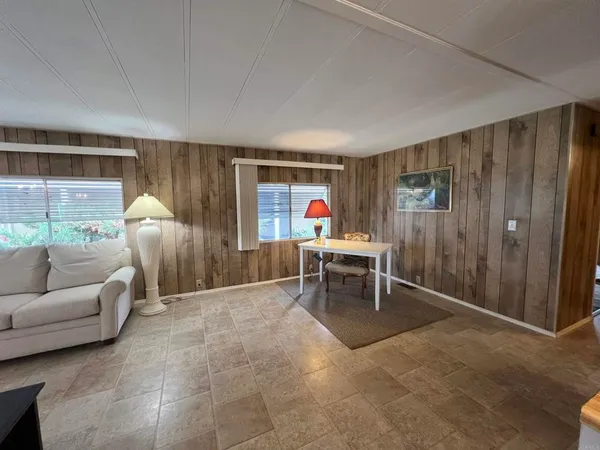 a living room with furniture a window and a table