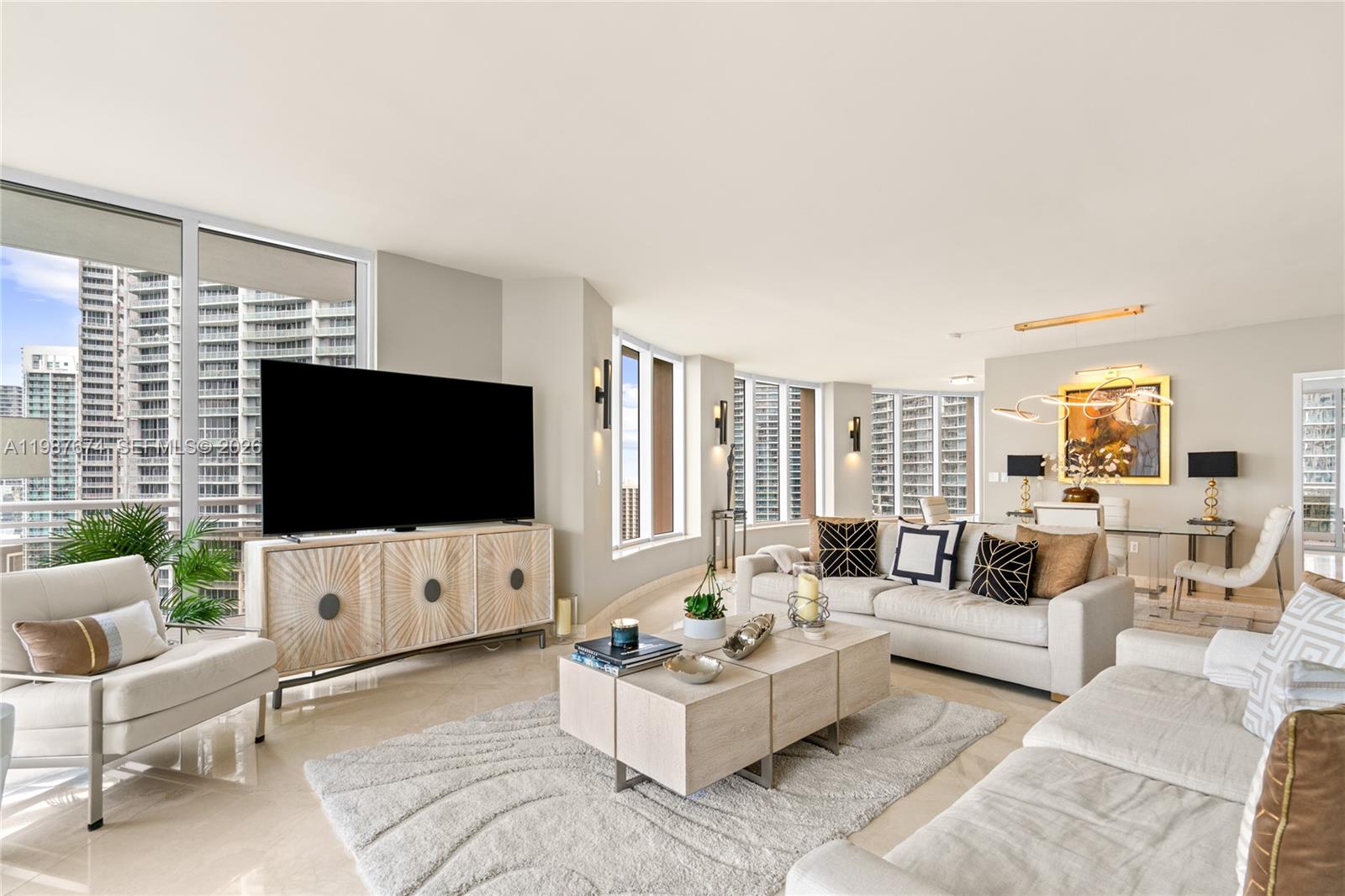 901 Brickell Key Boulevard, Unit 2804 Miami, FL 33131 - Photo 11 of 91 a living room with furniture and a flat screen tv