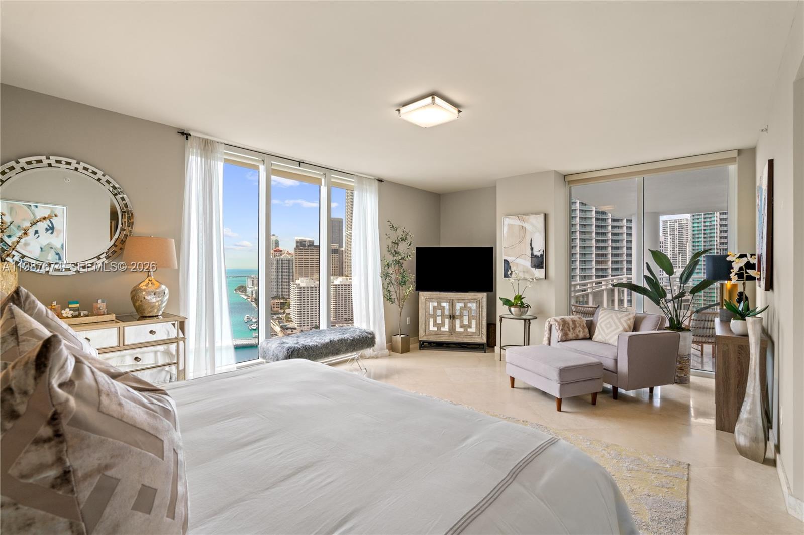 901 Brickell Key Boulevard, Unit 2804 Miami, FL 33131 - Photo 15 of 91 a bedroom with a bed and a flat screen tv