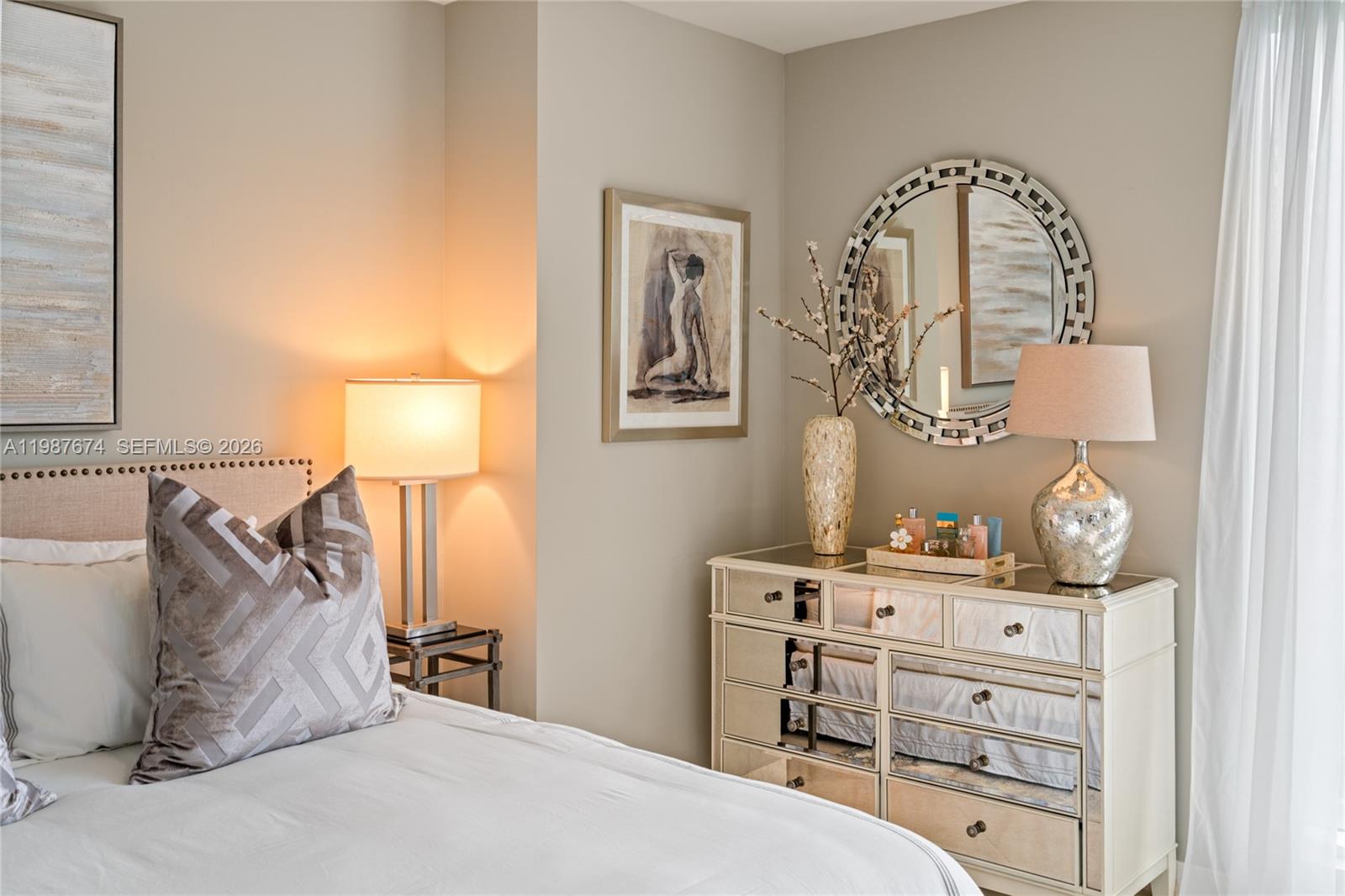 901 Brickell Key Boulevard, Unit 2804 Miami, FL 33131 - Photo 16 of 91 a bedroom with a bed and a dresser in it