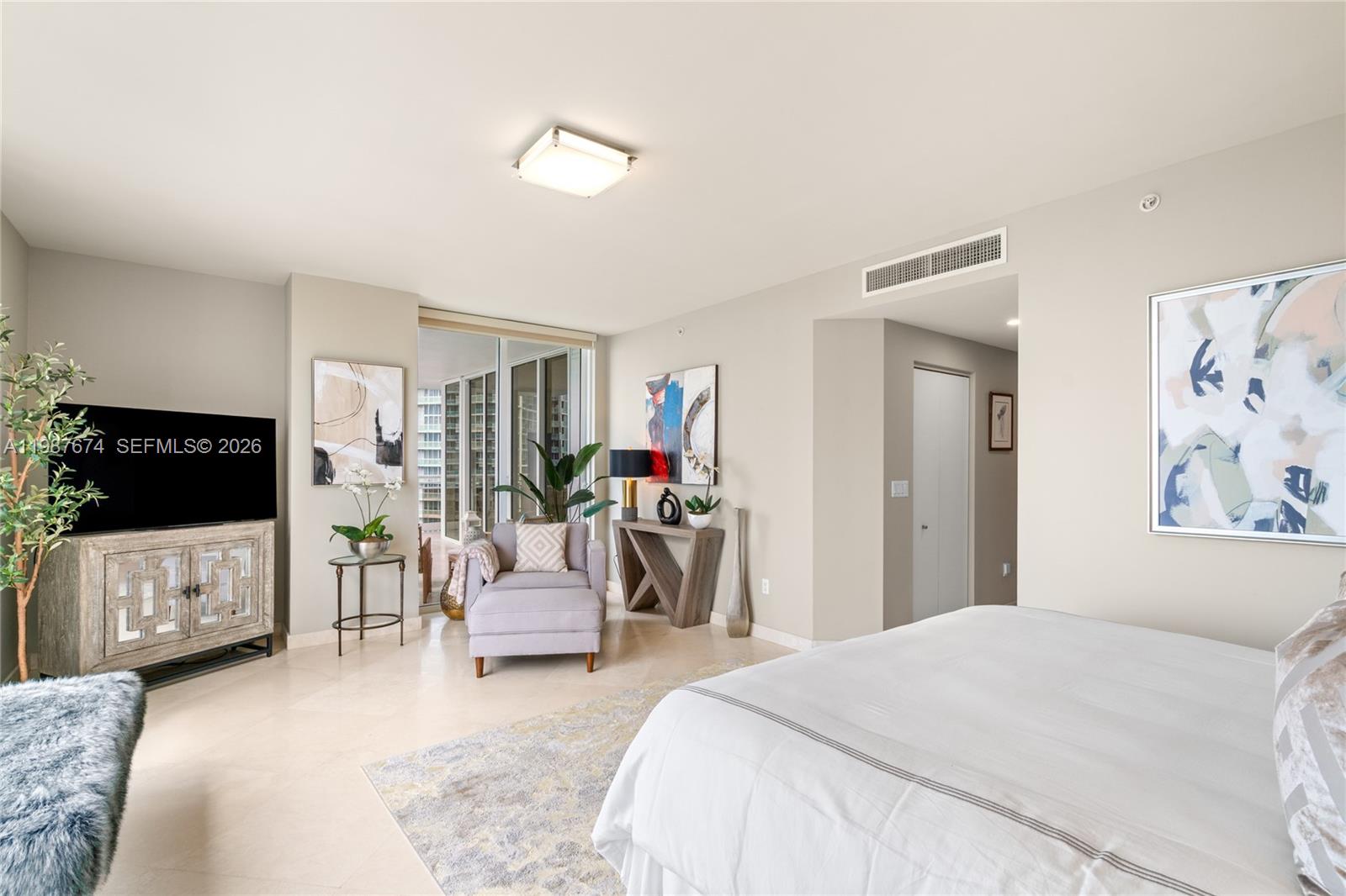 901 Brickell Key Boulevard, Unit 2804 Miami, FL 33131 - Photo 18 of 91 a bedroom with a bed and a flat screen tv