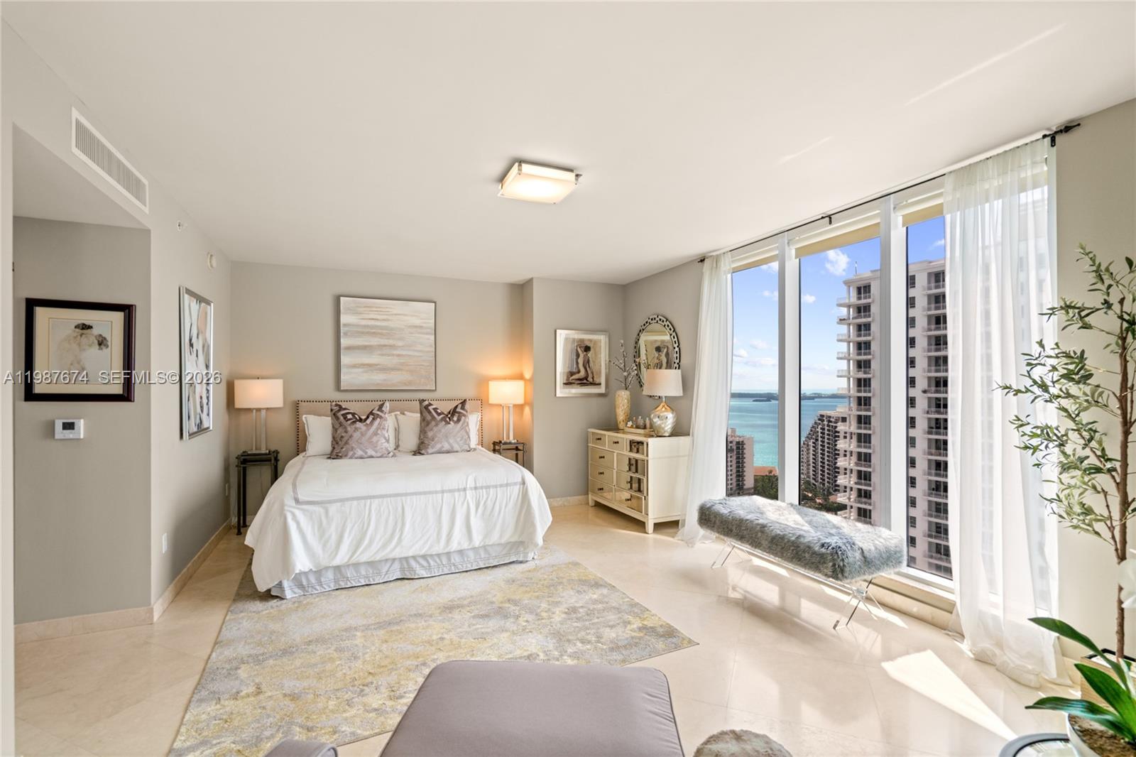 901 Brickell Key Boulevard, Unit 2804 Miami, FL 33131 - Photo 22 of 91 a bedroom with a large bed and a window