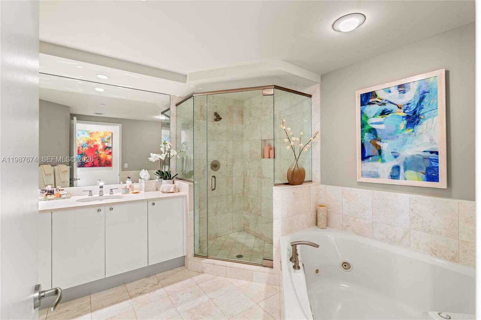 901 Brickell Key Boulevard, Unit 2804 Miami, FL 33131 - Photo 24 of 91 a bathroom with a tub a sink and a mirror
