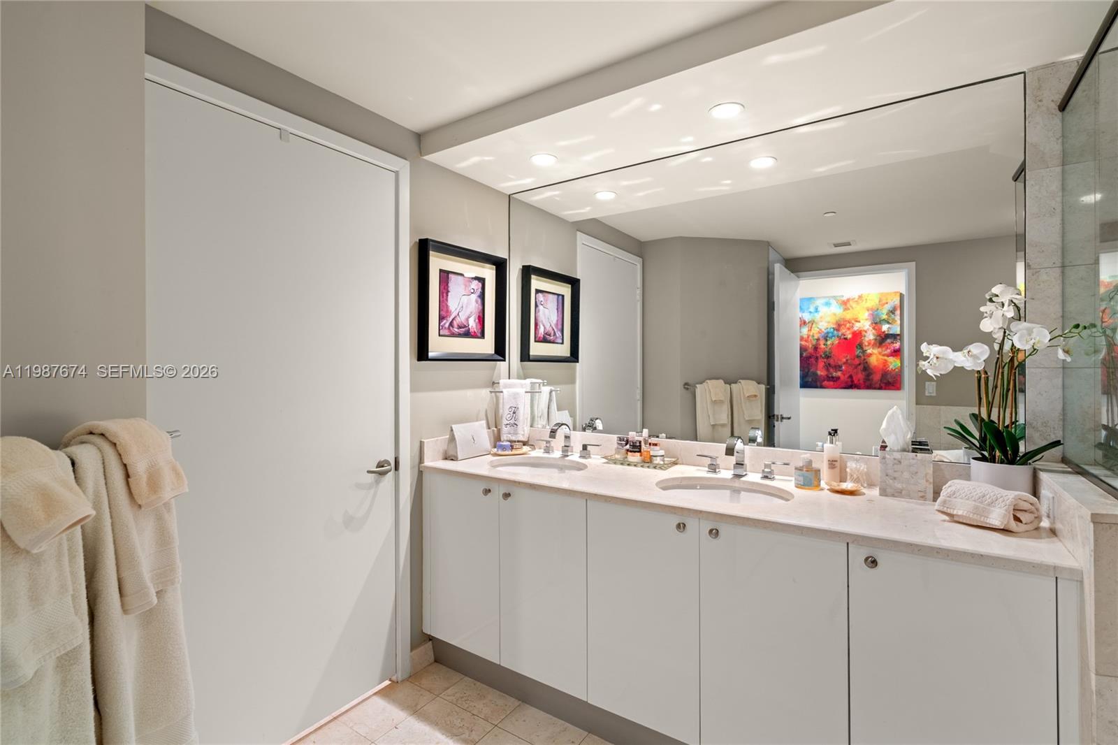 901 Brickell Key Boulevard, Unit 2804 Miami, FL 33131 - Photo 28 of 91 a bathroom with a sink and a mirror