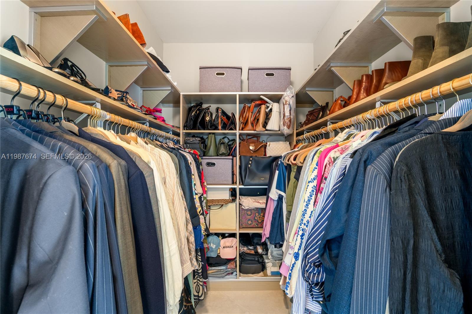 901 Brickell Key Boulevard, Unit 2804 Miami, FL 33131 - Photo 30 of 91 a view of walk in closet with clothes and shoes