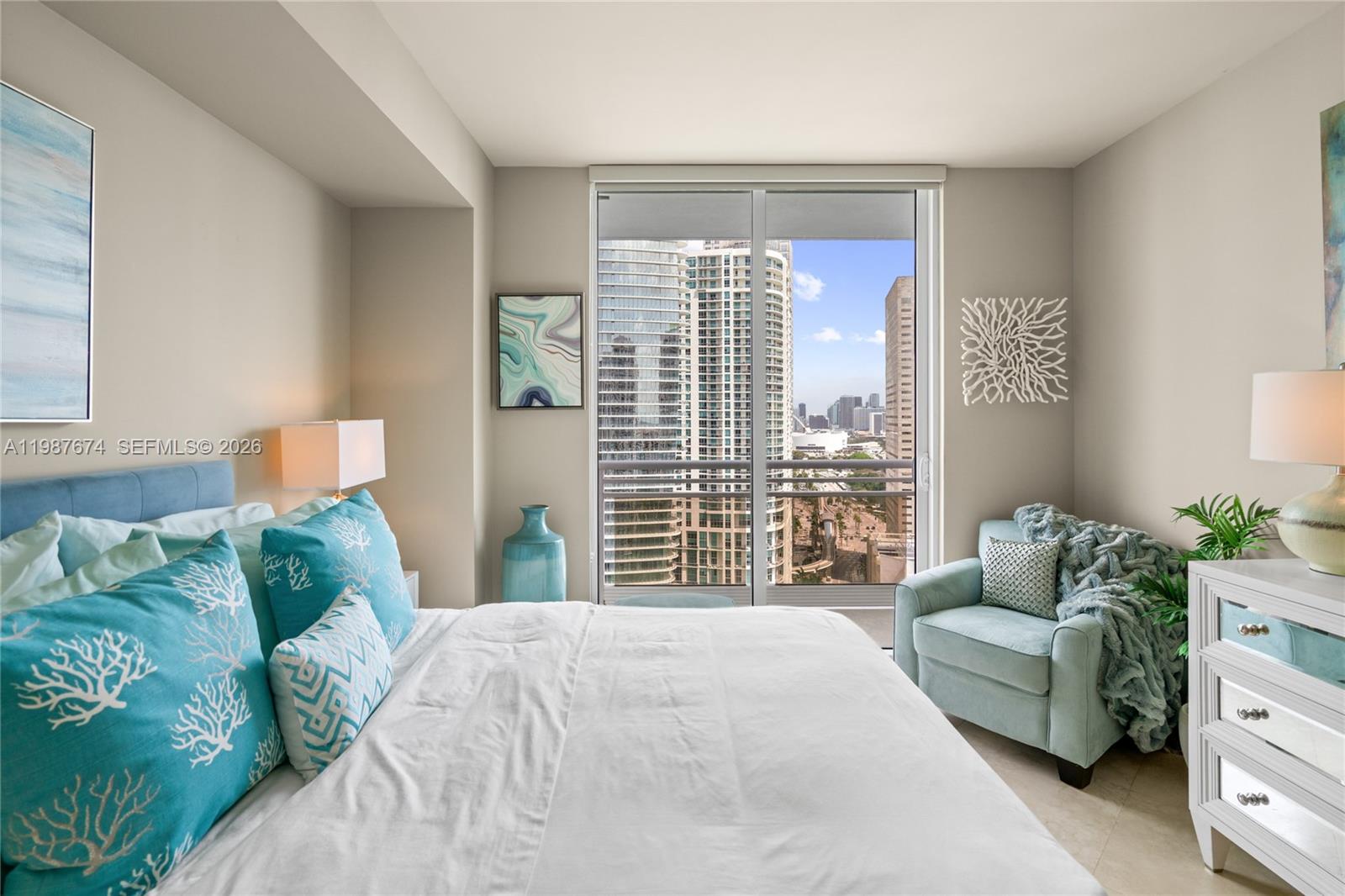 901 Brickell Key Boulevard, Unit 2804 Miami, FL 33131 - Photo 35 of 91 a bedroom with a large bed and a window