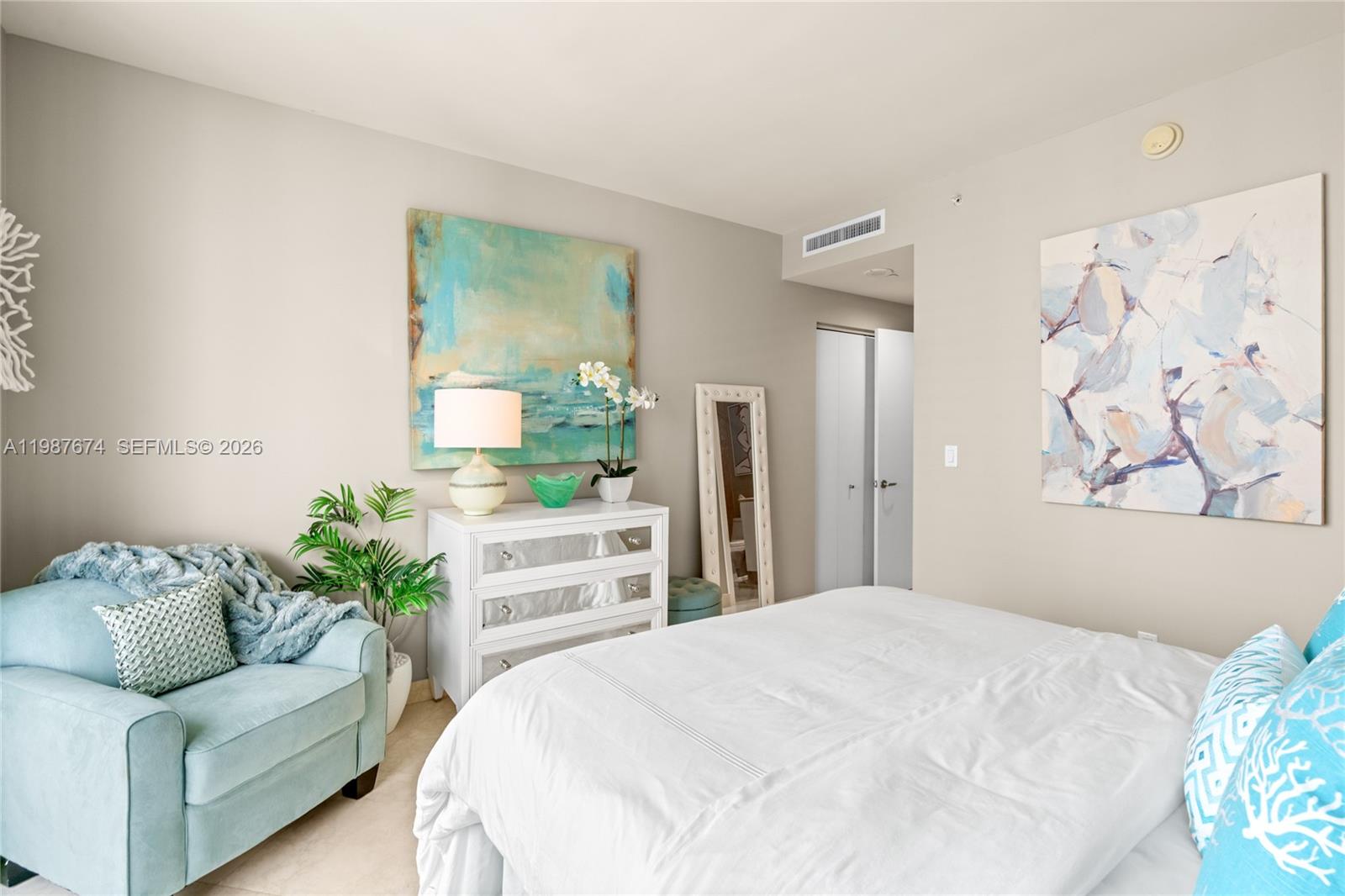 901 Brickell Key Boulevard, Unit 2804 Miami, FL 33131 - Photo 36 of 91 a bedroom with a bed couch and window
