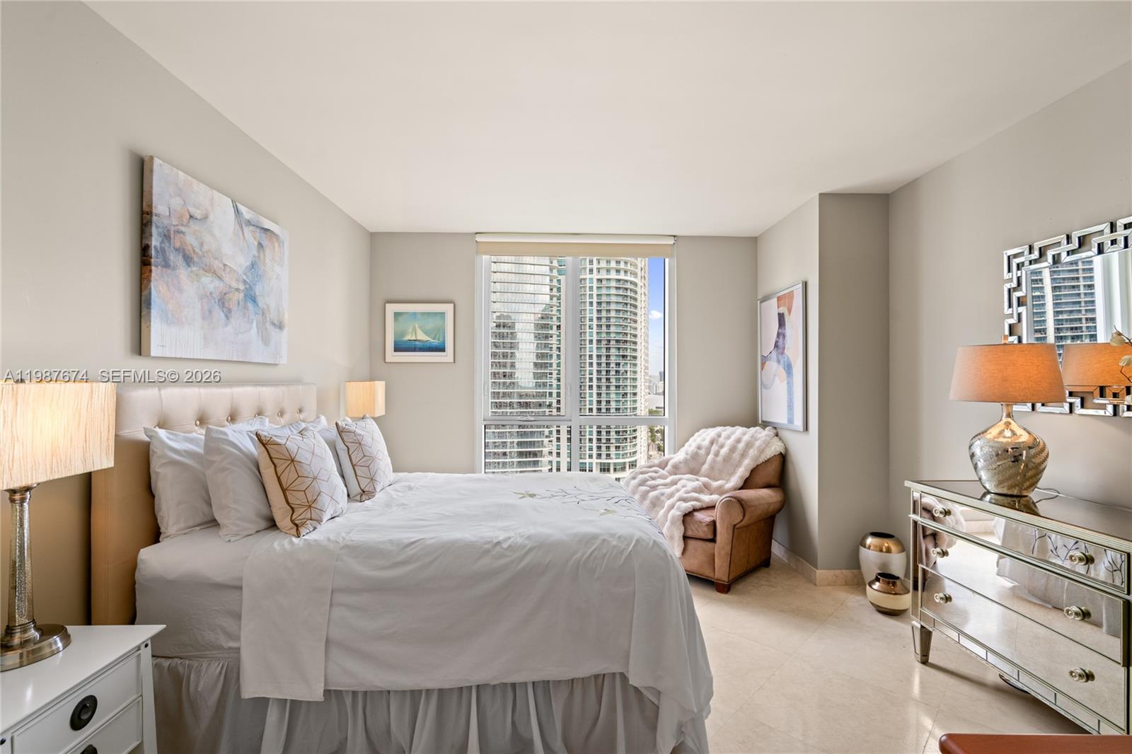 901 Brickell Key Boulevard, Unit 2804 Miami, FL 33131 - Photo 45 of 91 a bedroom with a bed and wooden floor