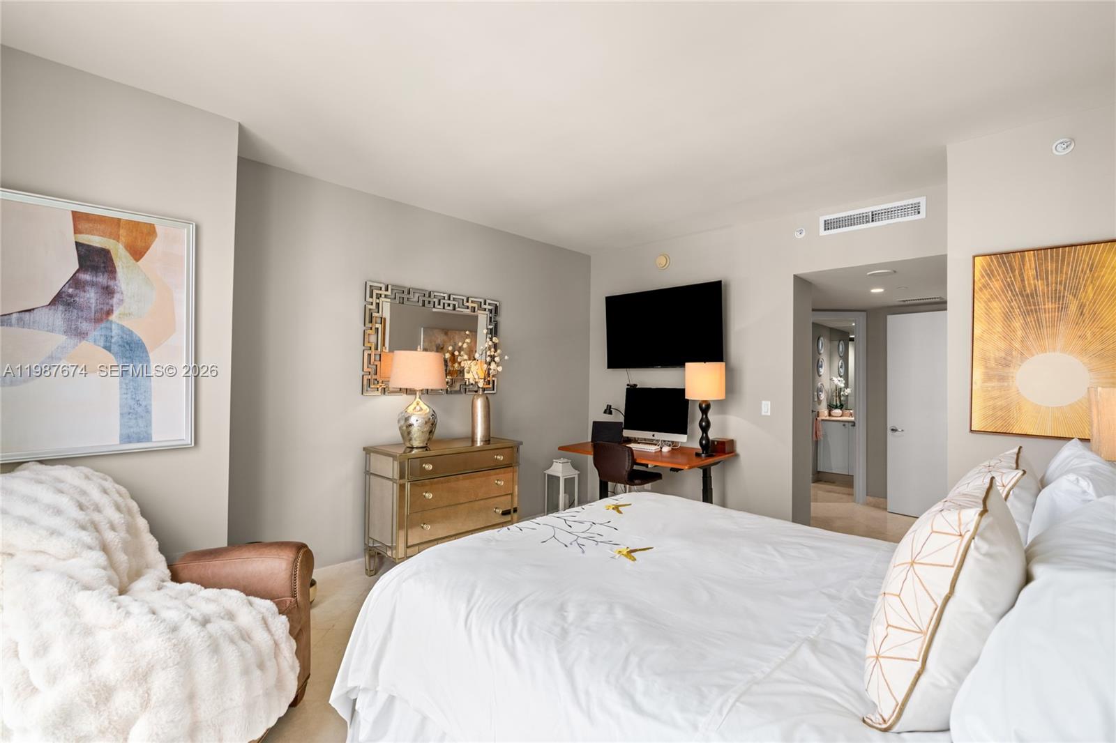 901 Brickell Key Boulevard, Unit 2804 Miami, FL 33131 - Photo 46 of 91 a bedroom with a bed and a flat tv screen on dresser