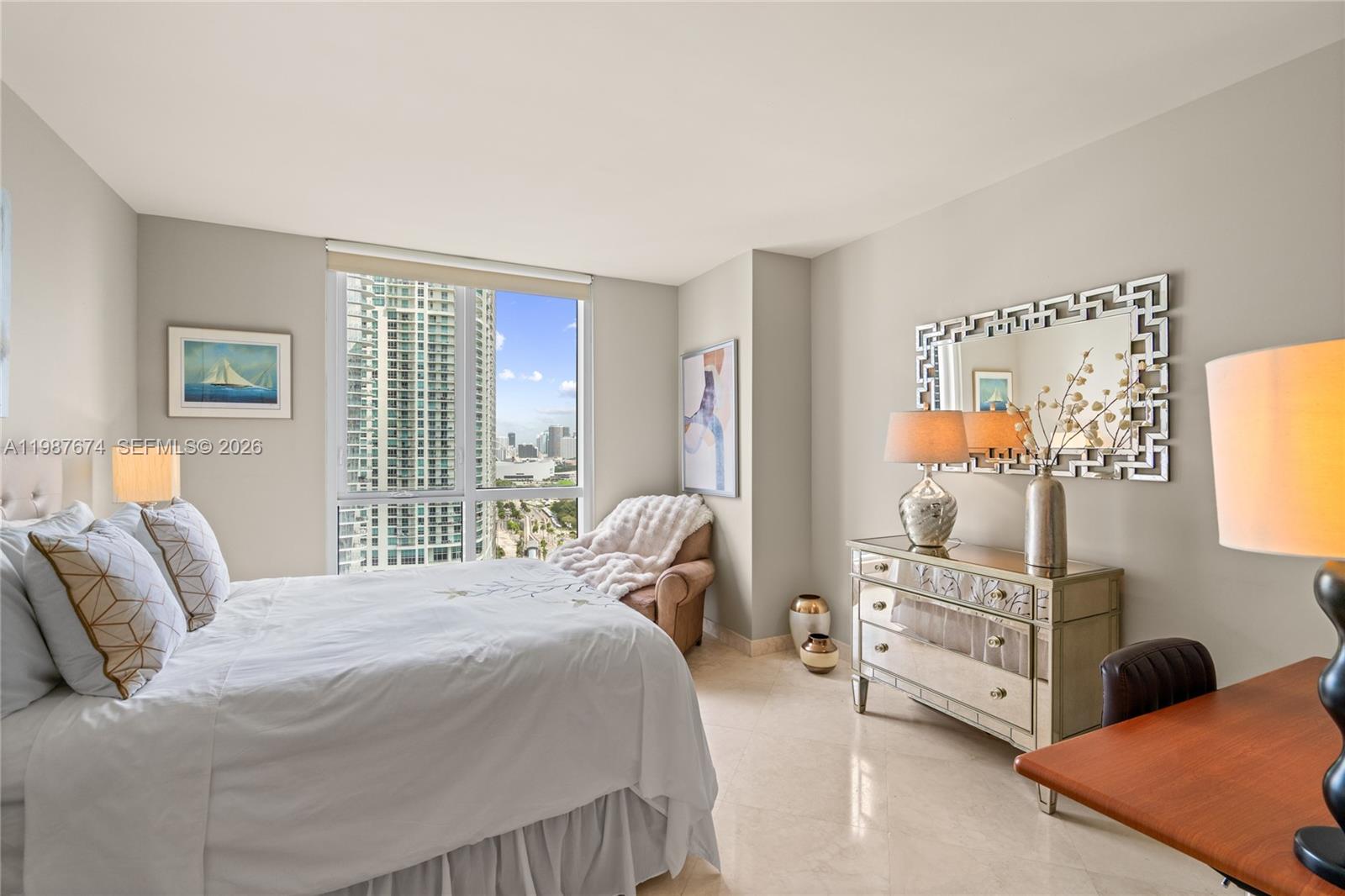 901 Brickell Key Boulevard, Unit 2804 Miami, FL 33131 - Photo 47 of 91 a bedroom with a bed and a window