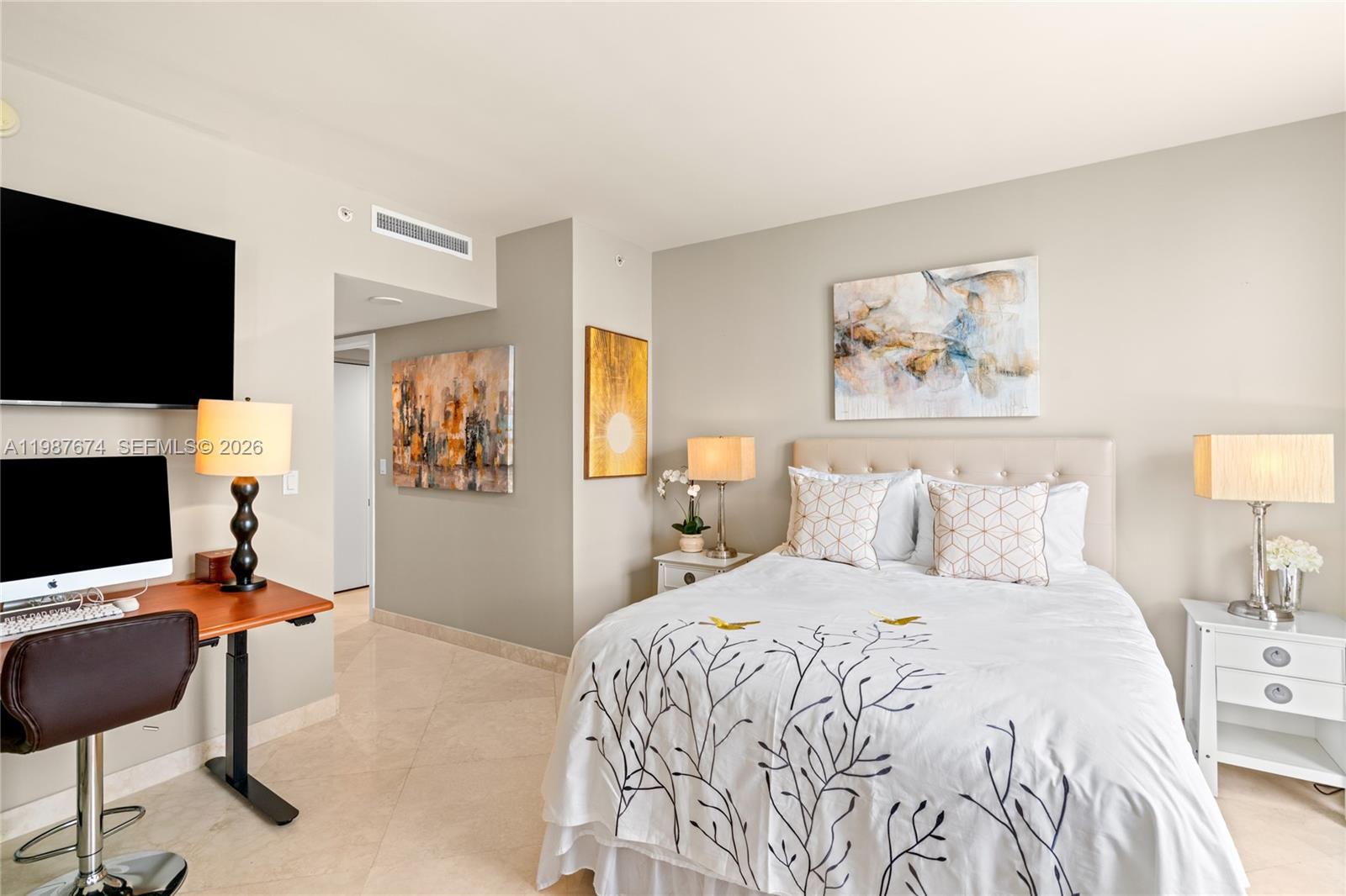 901 Brickell Key Boulevard, Unit 2804 Miami, FL 33131 - Photo 49 of 91 a bedroom with a bed and a flat screen tv