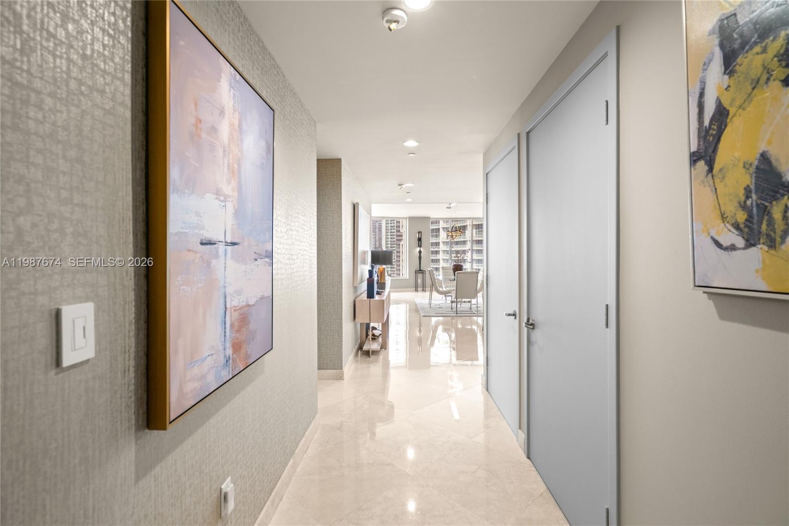 901 Brickell Key Boulevard, Unit 2804 Miami, FL 33131 - Photo 59 of 91 a view of a hallway with wooden floor and dining room