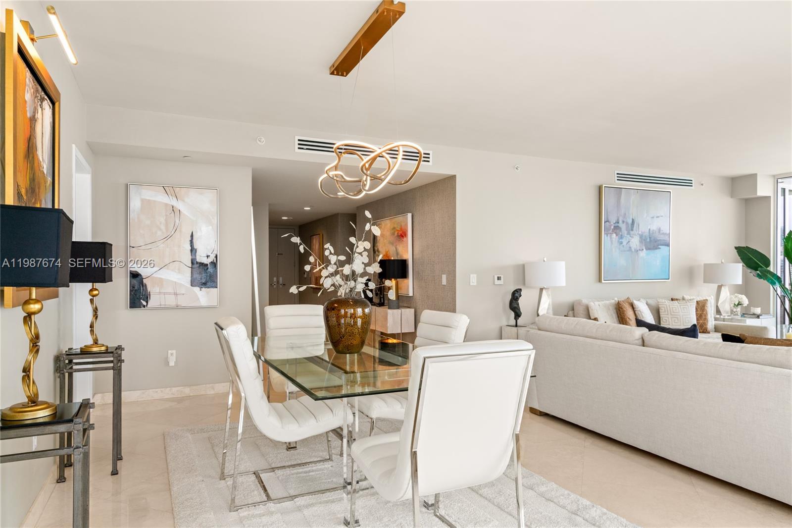 901 Brickell Key Boulevard, Unit 2804 Miami, FL 33131 - Photo 6 of 91 a view of a dining room with furniture and a chandelier