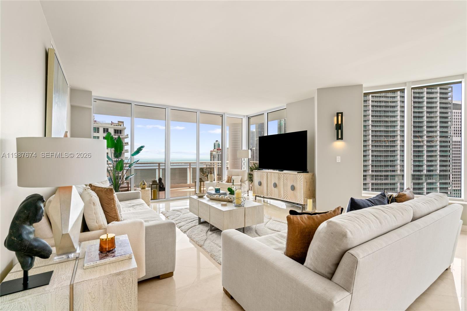 901 Brickell Key Boulevard, Unit 2804 Miami, FL 33131 - Photo 8 of 91 a living room with furniture and a flat screen tv