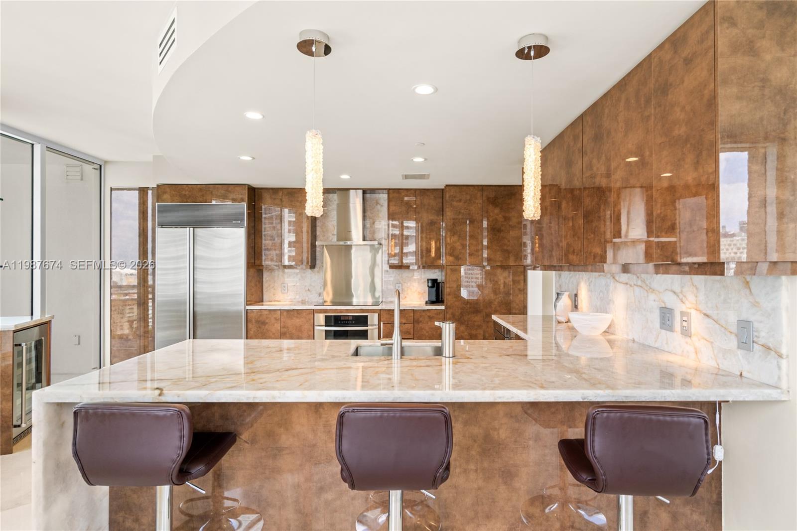 901 Brickell Key Boulevard, Unit 2804 Miami, FL 33131 - Photo 90 of 91 a kitchen with a dining table and chairs