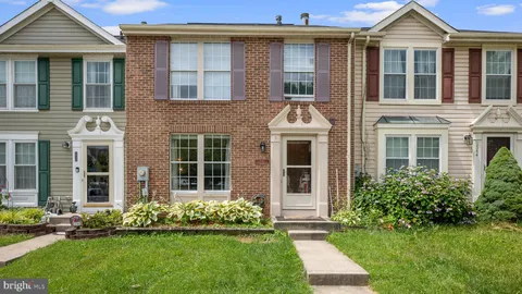 a front view of a house with a yard and outdoor seating
