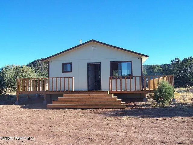 a front view of a house with wooden fence