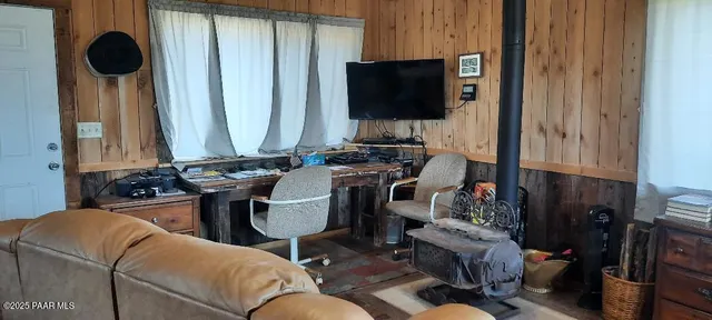 a living room with furniture a flat screen tv and a window